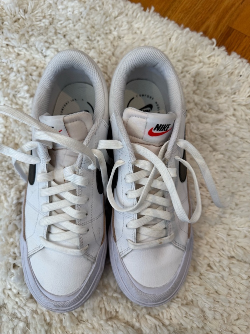 Nike White Low-Top Sneakers with Black Swoosh and Red Logo